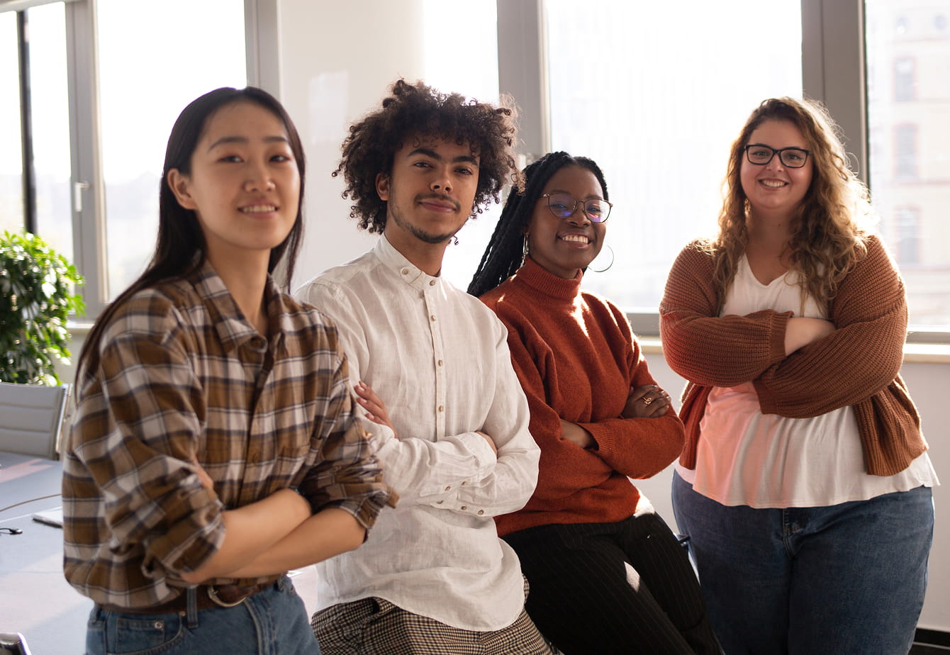 Confident young team members posing together in a modern workplace
